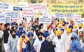 Dal Khalsa activists protest against the influx of migrants in the state, in Ludhiana on Monday