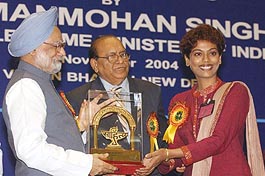 Prime Minister Manmohan Singh presents the Young Writers' award to Bengali poet Mandakranta Sen during the golden jubilee celebrations of Sahitya Akademi 