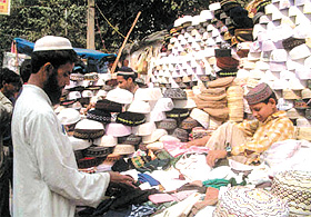 A man buys caps for Id in the Capital on Tuesday