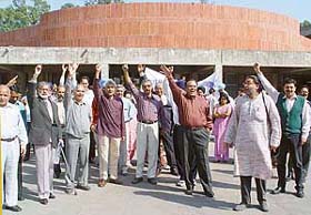 Members of the Panjab University Teachers Association raise slogans against the non-implementation of the pension scheme for university employees