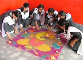 Students of Sacred Heart Convent School, Urban Estate, make rangoli at a competition in Ludhiana