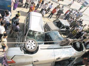 A car, which was being driven recklessly, turned turtle after crashing through several motor cycles and cars