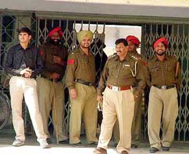 Cops guard the male surgical ward of the Mansa Civil Hospital, where BKU