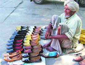 Thrown out of the house by his son, Jaagar Singh, 92, ekes out living by selling Punjabi juttis on a footpath near Fountain Chowk