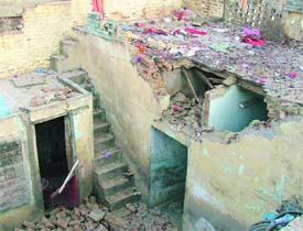 The damaged roof of a house in the Salim Tabri area after a blast took place inside the house where crackers were allegedly being manufactured illegally