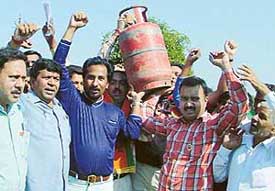 Members of the Bharatiya Janata Party, Panchkula, protest against hike in LPG and petrol prices at Sector 16/17 roundabout