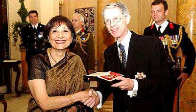The British Ambassador to the USA, Sir David Manning, presents on behalf of Britain's Queen Elizabeth, the Commander of the Most Excellent Order of the British Empire to Indian born actress and cookery writer Madhur Jaffrey