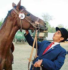 The best rider in the sub-junior category at the Chandigarh Horse Show --- 2004, Anant Rajpurohit, in a playful mood with his horse Manisha