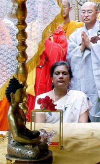 Sri Lankan President Chandrika Kumaratunga closes her eyes as she worships in the Diamond Seat at the Mahabodi Temple in Bodhgaya, some 150 km south of Patna, on Sunday. 
