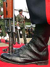 An unidentified disabled soldier walks past a war memorial