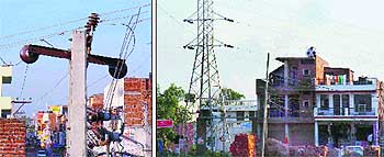 Several houses have enclosed poles of an 11-KV electricity line and buildings that have come up in violation of the law adjacent to a 66-KV transmission line in Govind Vihar Colony, Bartana village,  Zirakpur Nagar Panchayat.