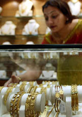 A saleswoman arranges gold jewellery at a shop in Mumbai