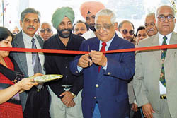 The Editor-in-Chief of The Tribune group of newspapers, Mr H.K. Dua, throws open the new newspaper building