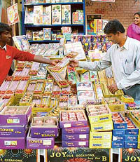 A buyer has a tough time selecting crackers in Sector 26, Chandigarh, on Wednesday.
