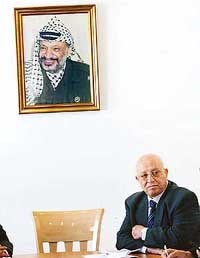 Palestinian Prime Minister Ahmed Qurei attends a meeting beside the empty chair of Palestinian President Yasser Arafat in the West Bank city of Ramallah on Wednesday.