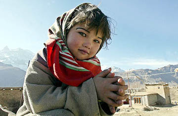 A girl poses on the roof of her house in Drass
