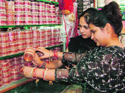Divali shoppers select traditional bangles on the eve of the festival.