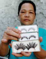 Socorro Bien, 52, shows the different kinds of false eyelashes that she hand-makes, using human hair from beauty parlours