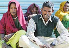 Grieving parents of three-month-old Mamta outside the mortuary of General Hospital, Sector 6