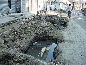 Stagnant water that has collected in a ditch on the Hamirpur-Shimla national highway following unplanned digging for laying sewers.