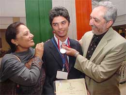 Ajeetesh Sandhu (golfer) from Chandigarh with his parents after receiving the National Child Award for Exceptional Achievement 2003 from Human Resource Development Minister Arjun Singh at a function in New Delhi on Sunday.