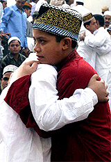 Bangladeshi boys hug each other after Id prayers outside the Baitul Mukarram National mosque in Dhaka 