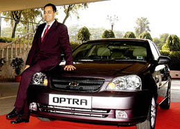 President and Managing Director of General Motors India Aditya Vij poses with Chevrolet Optra during the launching function of new look of the car in New Delhi on Tuesday. 