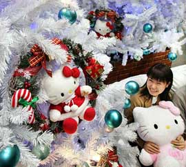 A Japanese student looks at popular feline character Hello Kitty used to decorate a Christmas tree in Tokyo on Tuesday.