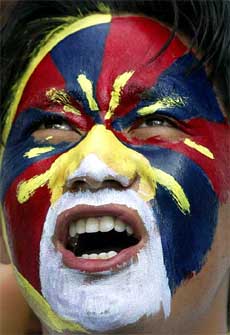 A Tibetan Youth Congress activist, with his face painted with colours of the Tibetan flag, shouts slogans during a demonstration in Chandigarh on Tuesday
