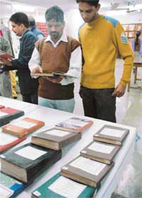 Visitors scan rare books displayed at the Dwarka Dass Library in Lajpat Rai Bhavan in Chandigarh on Tuesday. 