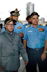 Defence Minister Pranab Mukherjee is escorted by Vice-Admiral S.K.K. Krishnan and Vice-Admiral Madamjit Singh as he visits the Naval Dockyard in Mumbai on Tuesday