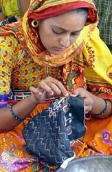 A woman sews inside a workshop in Jakhotra village, 260 km north of western Ahmedabad, in this picture taken on June 2.