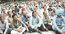 Members of the Panjab University teaching and non-teaching staff sit in dharna outside the Vice-Chancellors office on Wednesday.