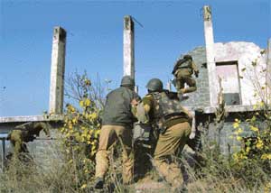 Central Reserve Police Force jawans storm a building during an encounter in Srinagar on Wednesday.