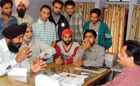 Victims of emigration fraud narrate their tale of woes to Inspector Anil Joshi, in charge, EO Wing of the city police