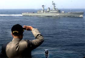 Defence Minister Pranab Mukherjee takes the salute from Navy personnel during a 'Day at Sea' exercise organised for the minister who visited the Naval Headquarters in Mumbai