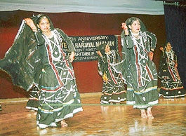 Children perform during an inter-school dance competition at Moti Ram Arya School, 