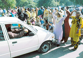 Residents of Mataur village block traffic in Phase VII Mohali in protest against demolition of toilets in the village by PUDA on Thursday.