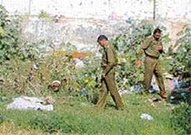 Police at the pond site from where the bodies were recovered
