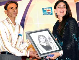 Local painter Ashok Kumar presents a portrait of Kareena Kapoor to the film actress in a hotel in Ludhiana on Friday evening