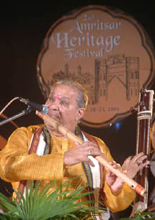 Flutist Pandit Hari Prasad Chaurasia performs at Khalsa College in Amritsar during the second heritage festival on Thursday. 