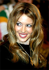 Australian singer Kylie Minogue smiles as she arrives for the MTV Europe music awards ceremony in Rome