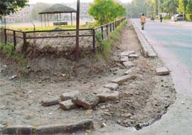After the imposition of the model code of conduct, development work has come to a standstill. This footpath in Sector 22-C, which had been dug up to lay tiles, is lying unattended. 