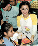 Actress Diya Mirza serving on the occasion of World Childrens Day celebration. She supports the cause of paediatric eye care in the Capital on Saturday.