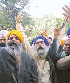 Visa aspirants raise slogans against the SGPC after the denial of visas by the Pakistan Embassy in Amritsar on Sunday.