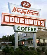 Struggling doughnut shop chain, Krispy Kreme Doughnuts Inc., reported an unexpected quarterly loss, hurt by store closing costs and sluggish sales on Monday