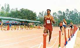 Rajveer Singh of Kumaon Sector races to glory in the 24th ITBP inter-sector athletics meet at the BTC, Ramgarh, on Monday.