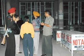 Onlookers at the District Courts in Chandigarh wait for a CBI team to come out after arresting two court officials on a bribery charge. 