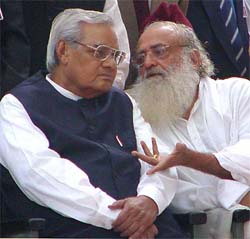 Asharam Bapu talks with BJP leader Atal Behari Vajpayee at a rally to protest against the arrest of Kanchi seer Jayendra Saraswati at Parliament Street in New Delhi