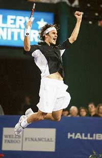 Roger Federer of Switzerland leaps in the air after defeating Lleyton Hewitt of Australia to win the Tennis Masters Cup at Westside Tennis Club in Houston on Sunday